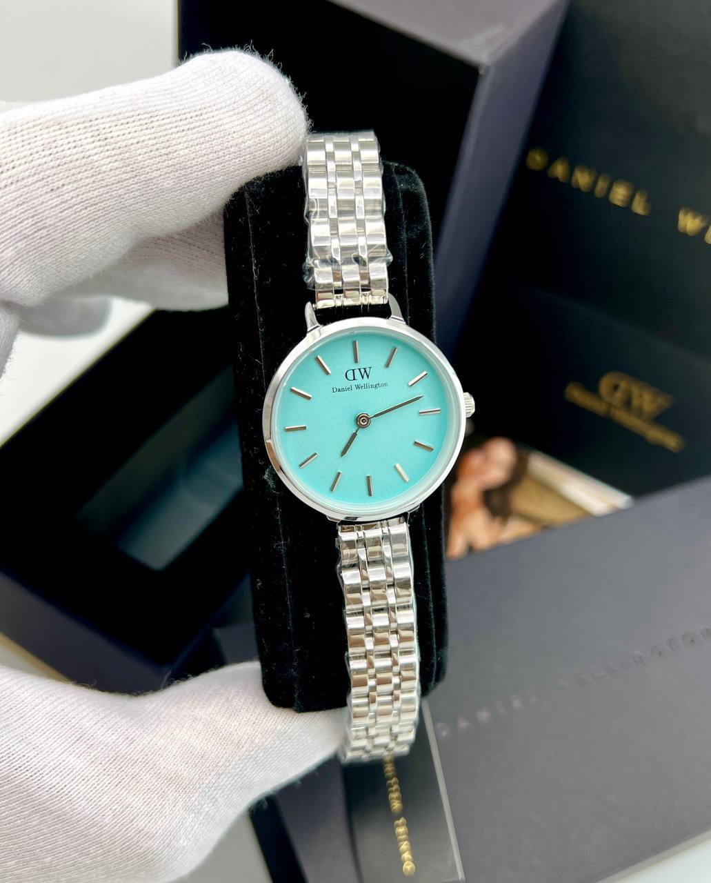 ساعت مچی زنانه دنیل ولینگتون DW (22) صفحه فیروزه ای اندیس خطی بند استیل