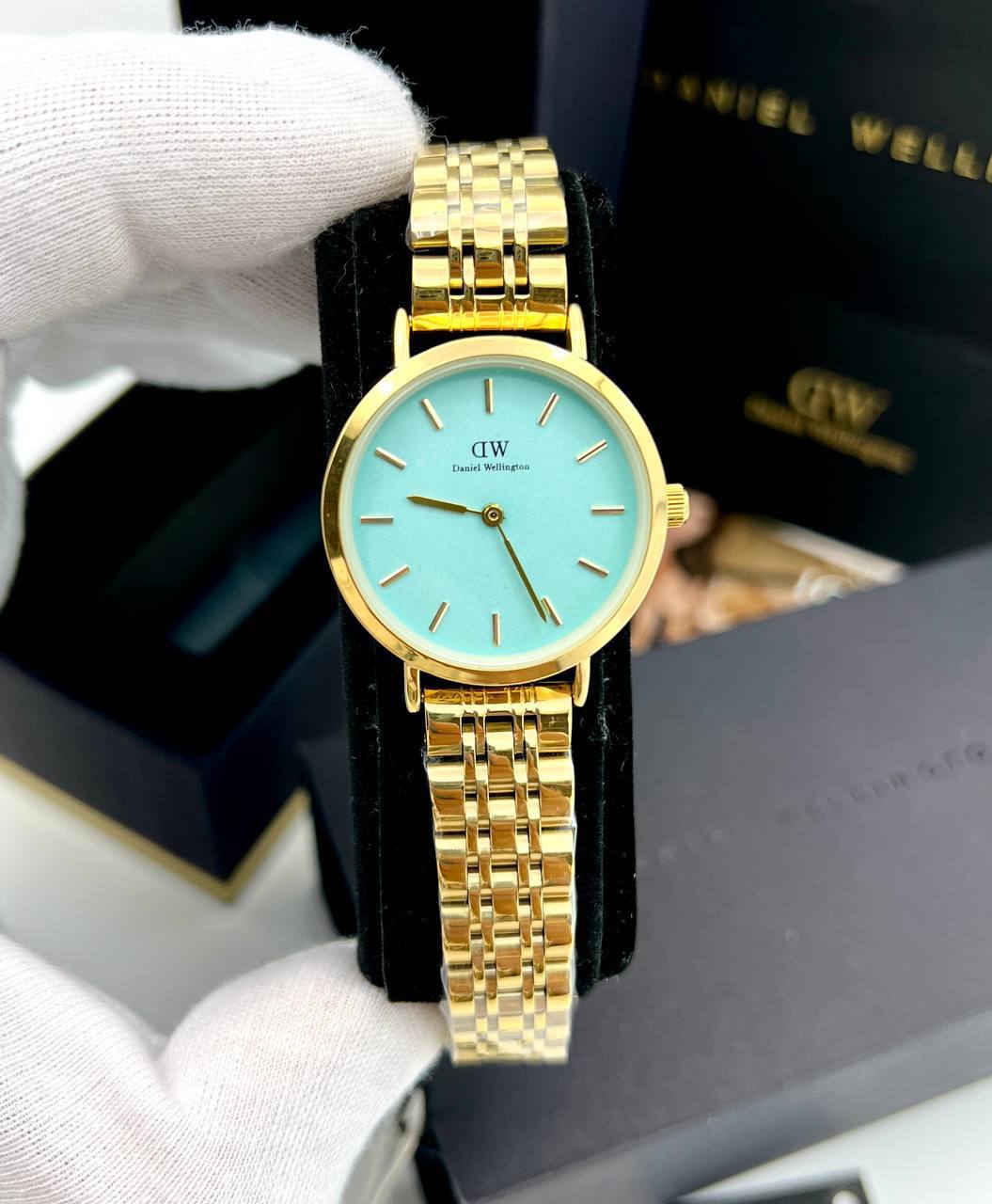 ساعت مچی زنانه دنیل ولینگتون DW (29) صفحه فیروزه ای اندیس خطی بند طلایی